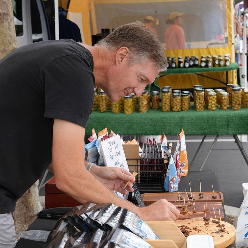 Jeff Wain preparing biltong samples at a farmers market